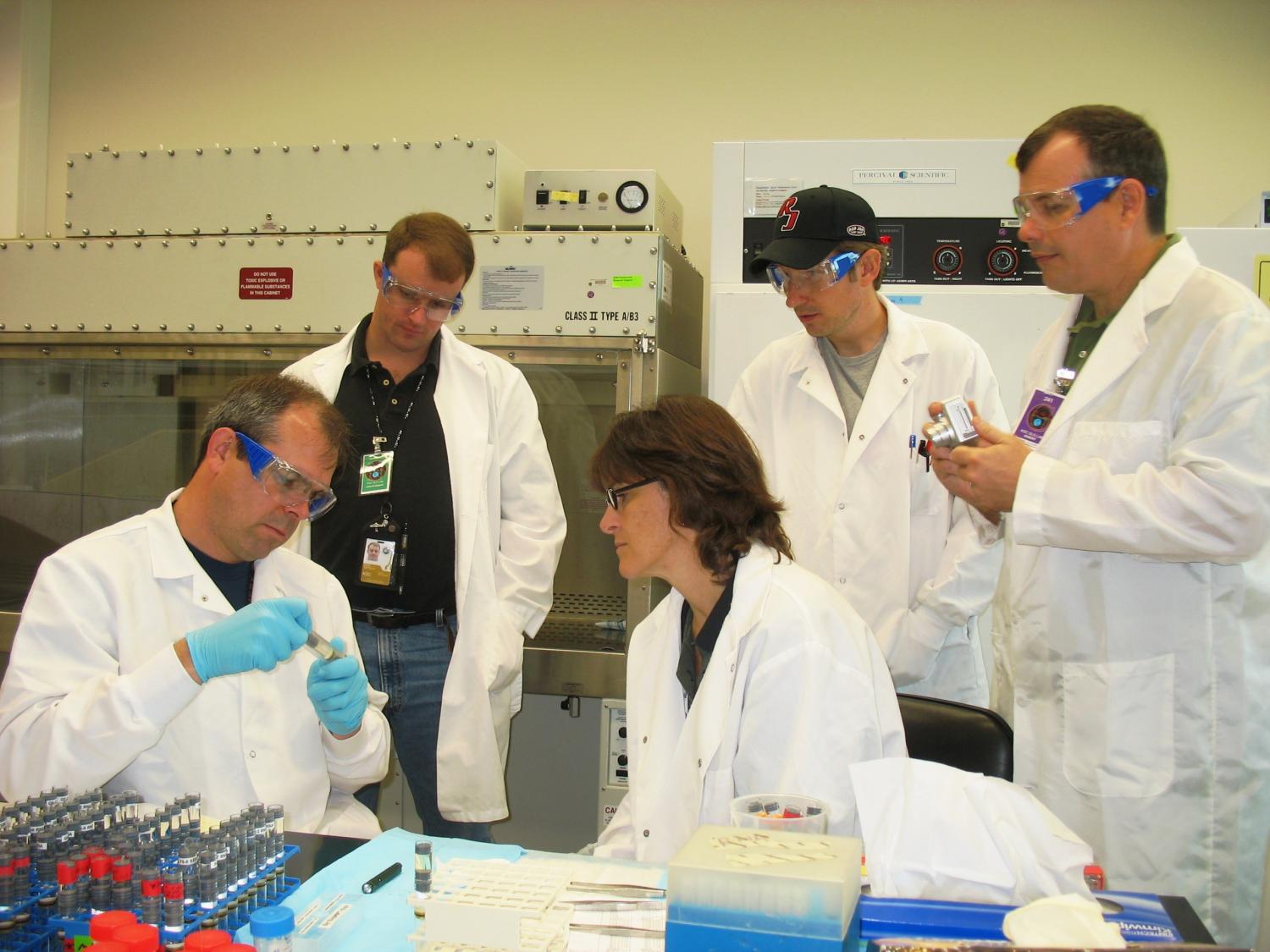 BioServe personnel in 2006 preparing FPA hardware for STS-115 at KSC