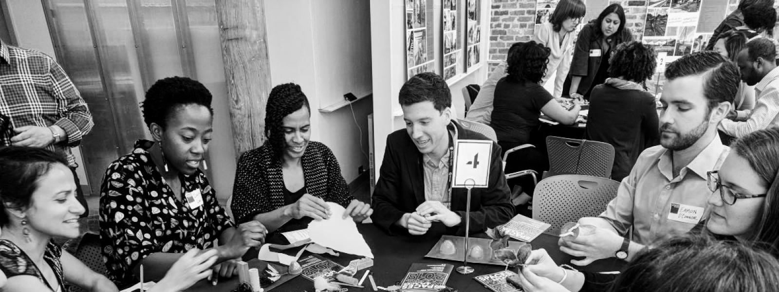 Dialogue of people seated around a table engaging each other