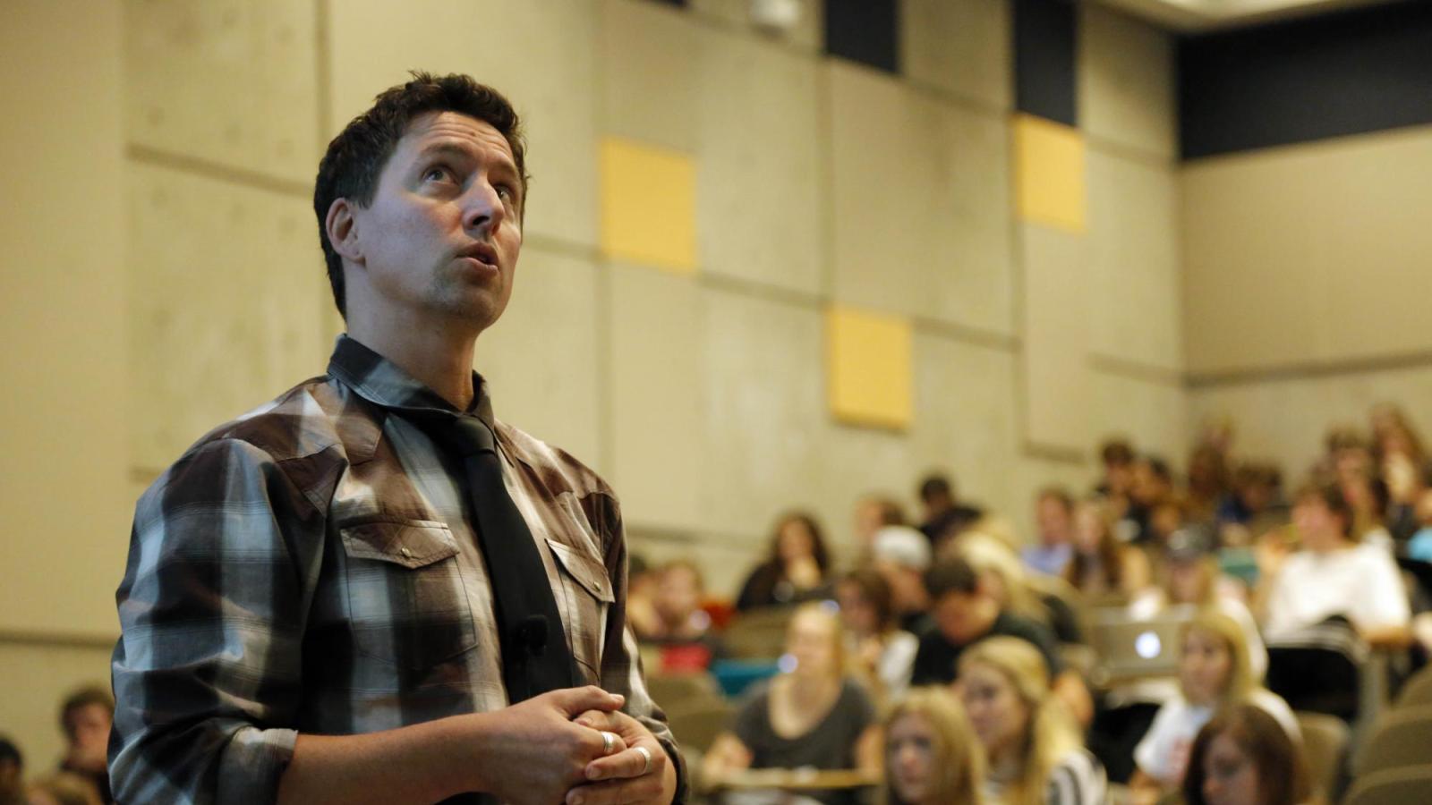 Professor teaching in front of large lecture