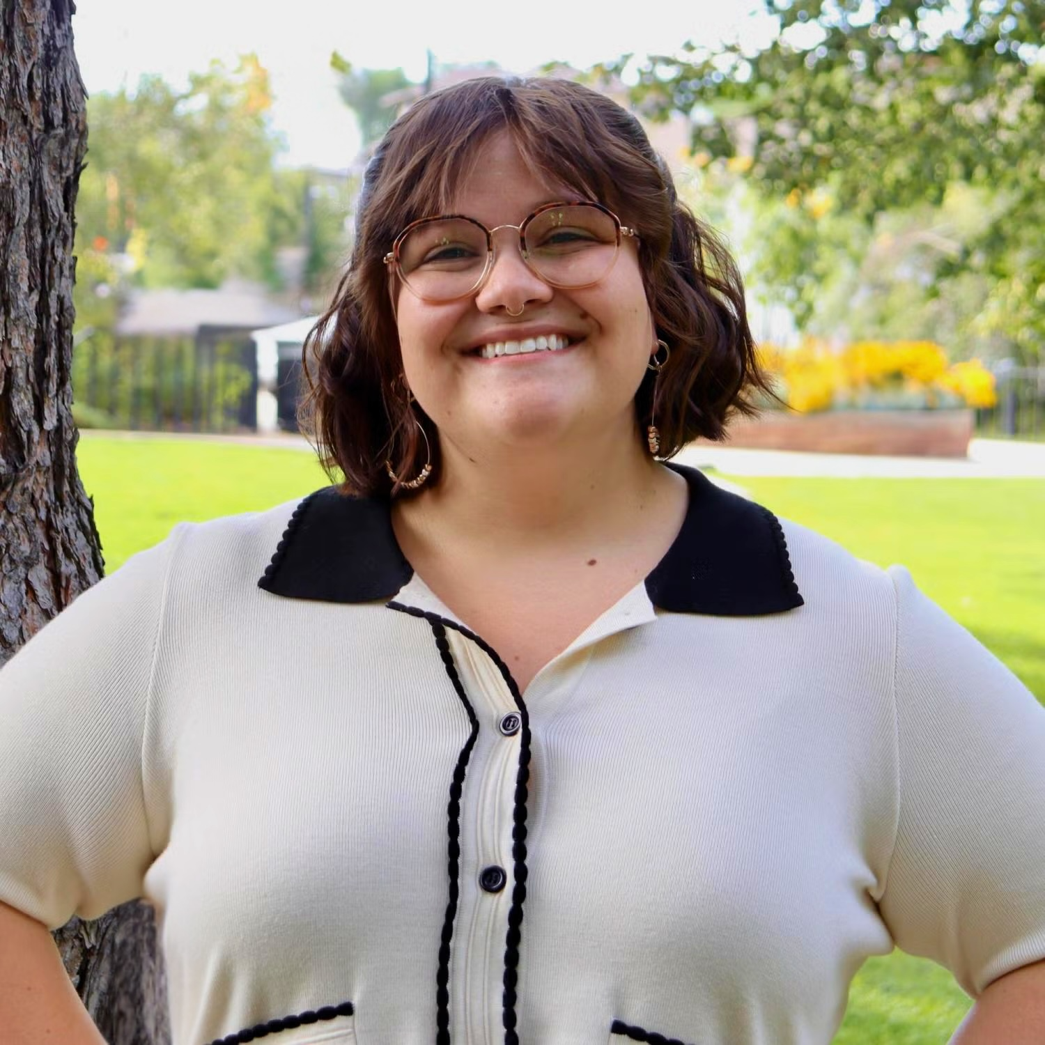 Photo of Maren smiling in front of park