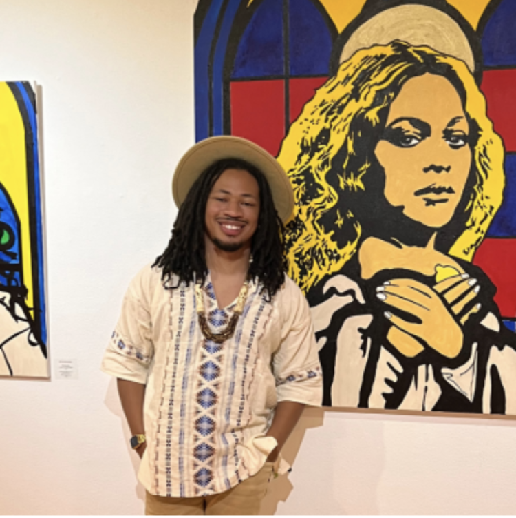 Headshot of John with painting in the background.
