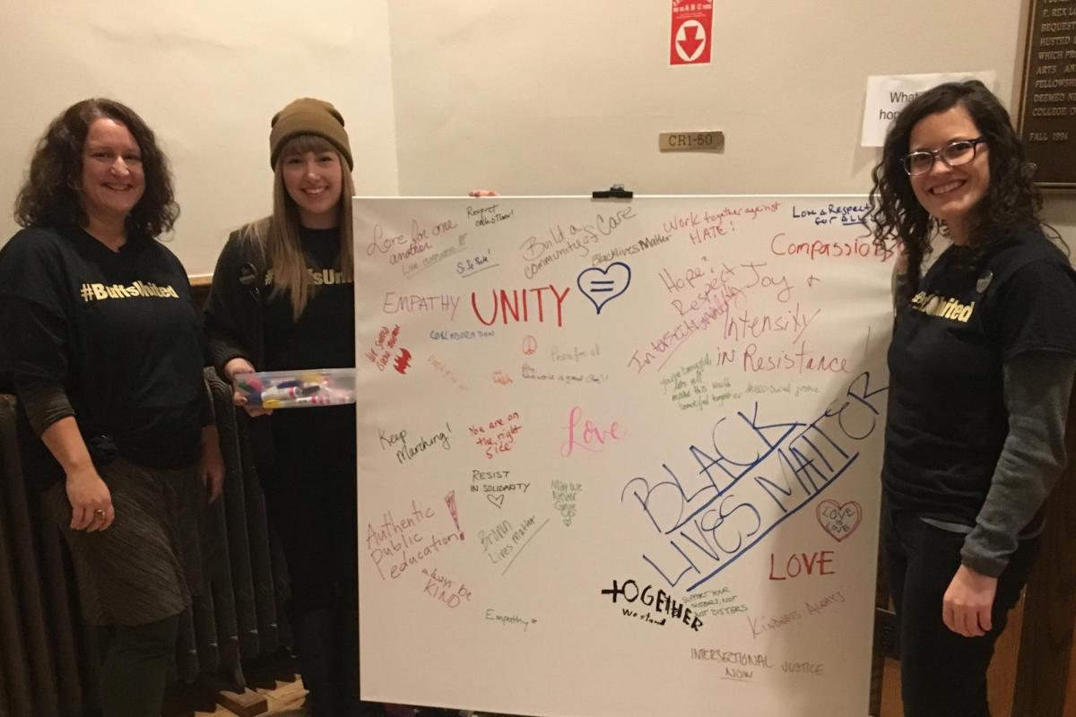 group of individuals holding a sign