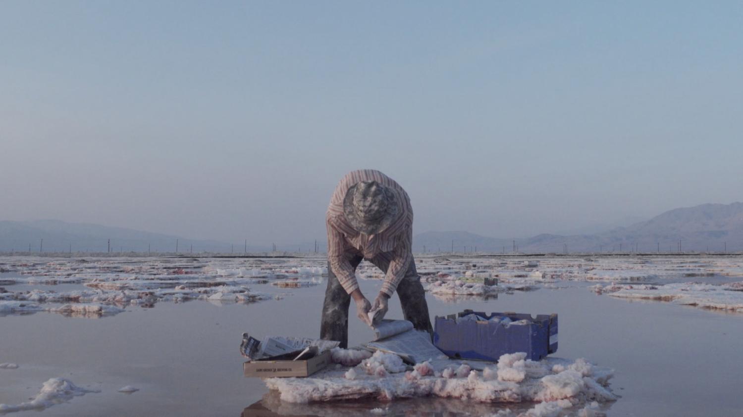 Man harvesting salt from salt flats in California.