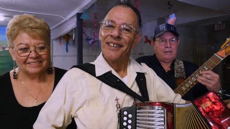 A contigo band led by a man playing accordion.