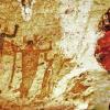 A photo collage of cave paintings with a portrait of Jimi Hendrix.