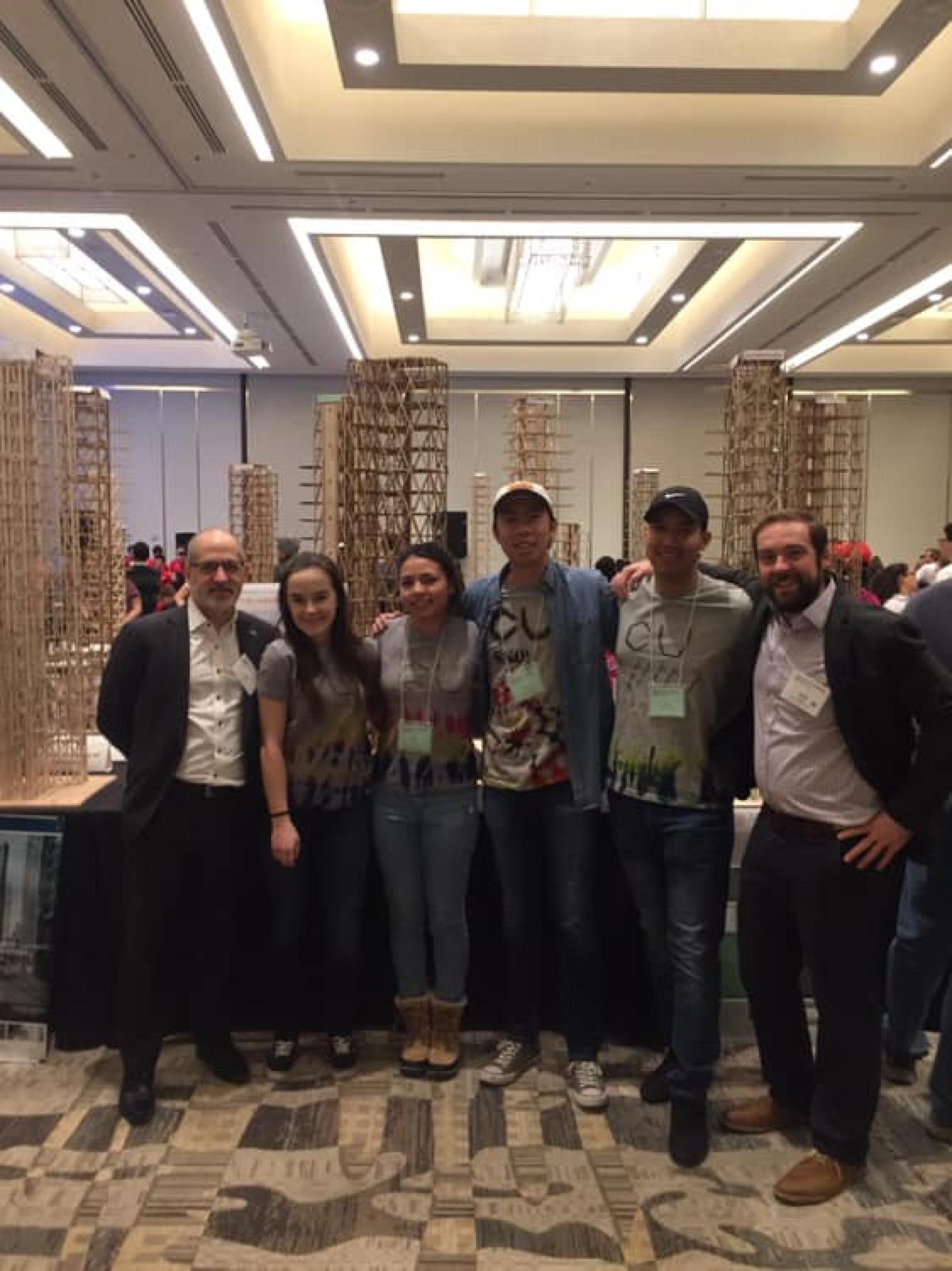 Students pose with their constructed building