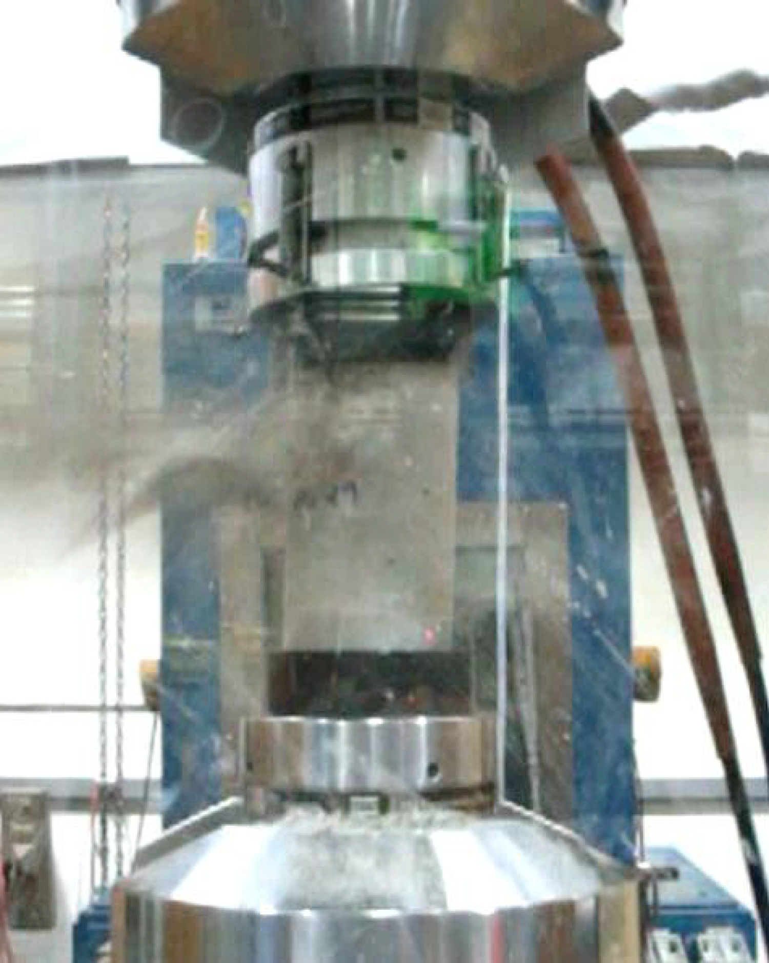 A concrete sample breaks under pressure during an experiment.