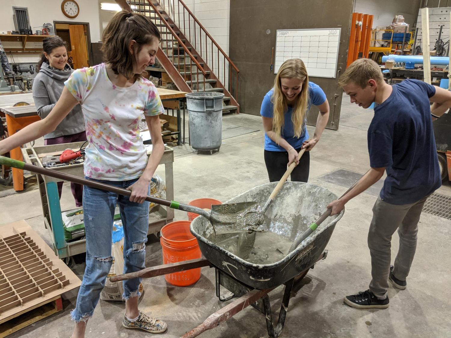 Anna and friends work with concrete mix