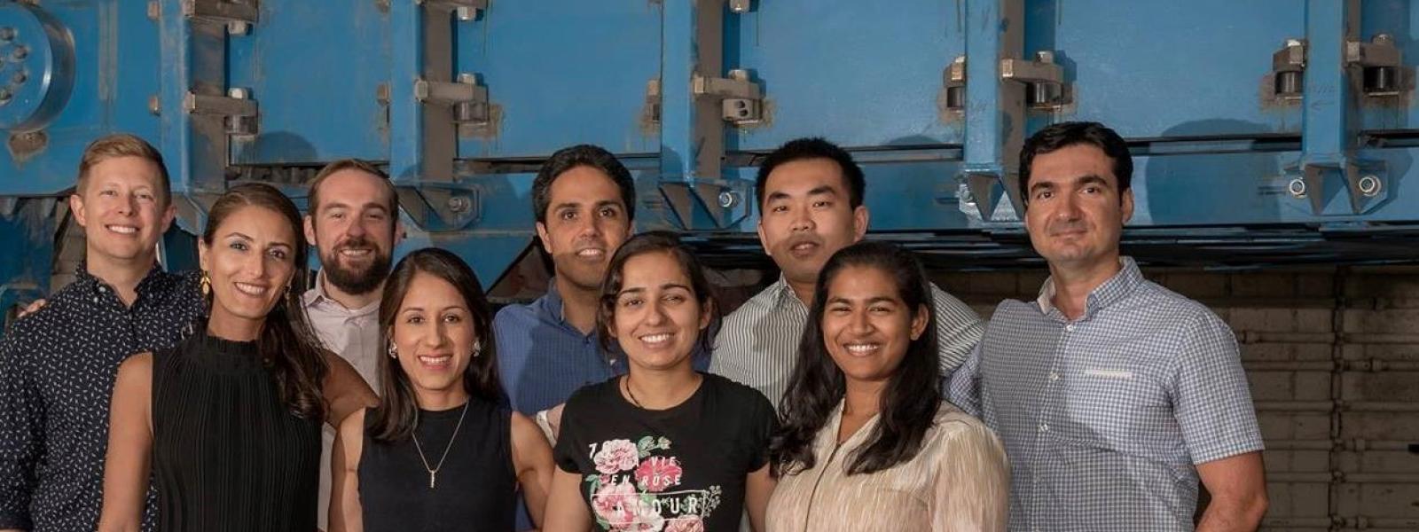 A group of students next to the 400 g-ton centrifuge