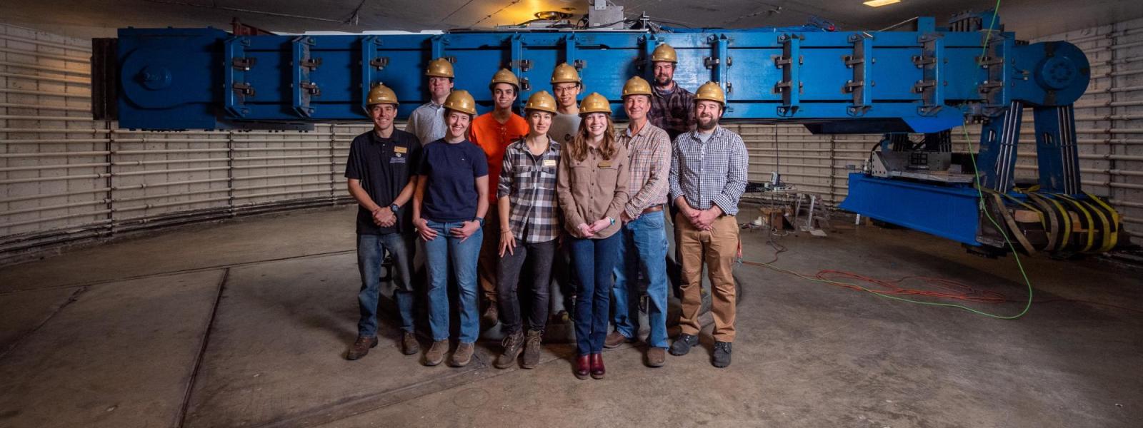CIEST team members posing for group photo in front of centrifuge
