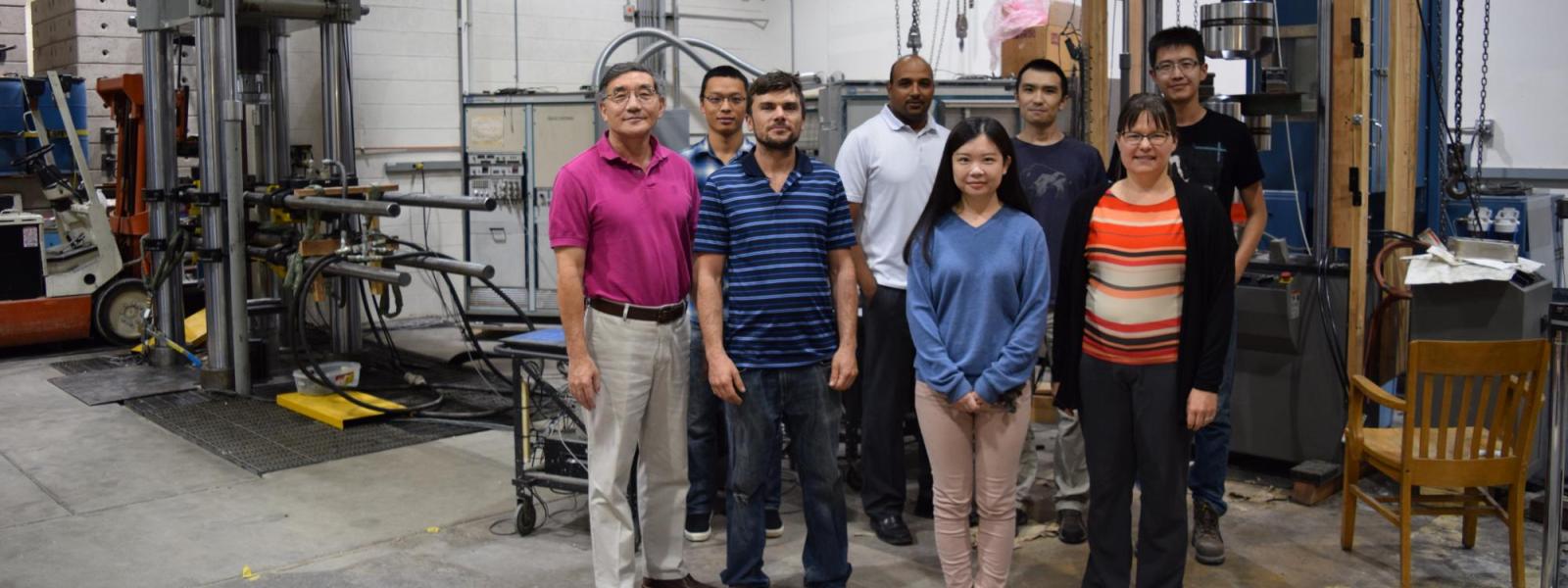 A group shot of Yunping Xi, Mija Hubler and their students in the structures lab.