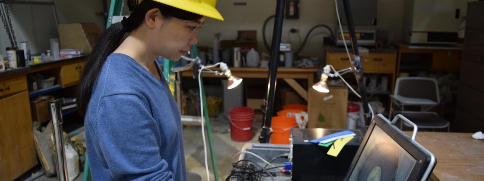 A student looks at the results of a materials experiment on a computer screen.