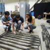 A group of students discuss the design of their steel bridge