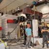 The project team with a concrete column in the loading frame