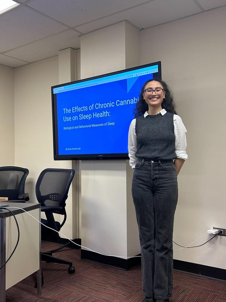 Gray in front of Honors Thesis Presentation