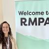 Samantha Melendez in front of RMPA banner