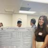 Megan Next to Poster