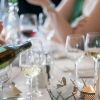 hand pouring wine from bottle into glass