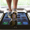 Feet running on treadmill with smartphone image on track