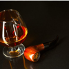 brandy glass with smoking pipe