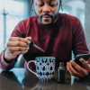 Man dropping CBD into mug