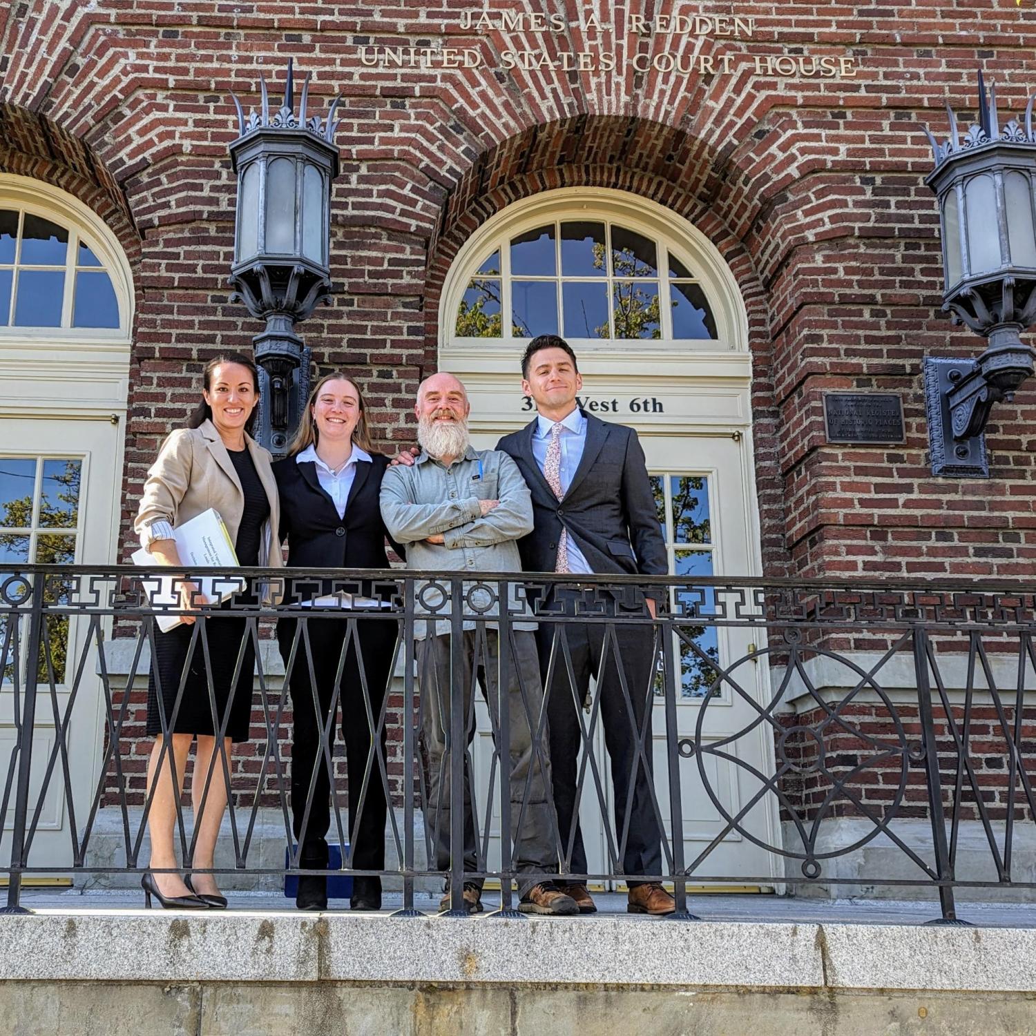 Legal Team in Front of Courthouse