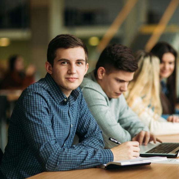 Group of college students studying in the school library