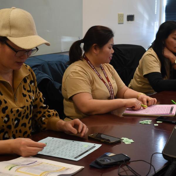 Three employees sitting at a table