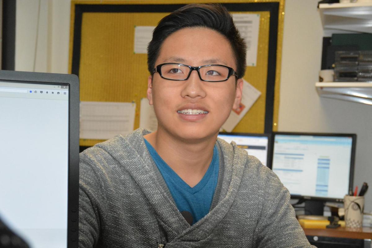 Student sitting at desk with academic advisor.