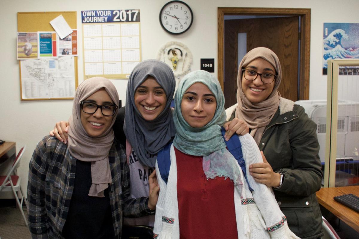 Group of smiling IEC students.