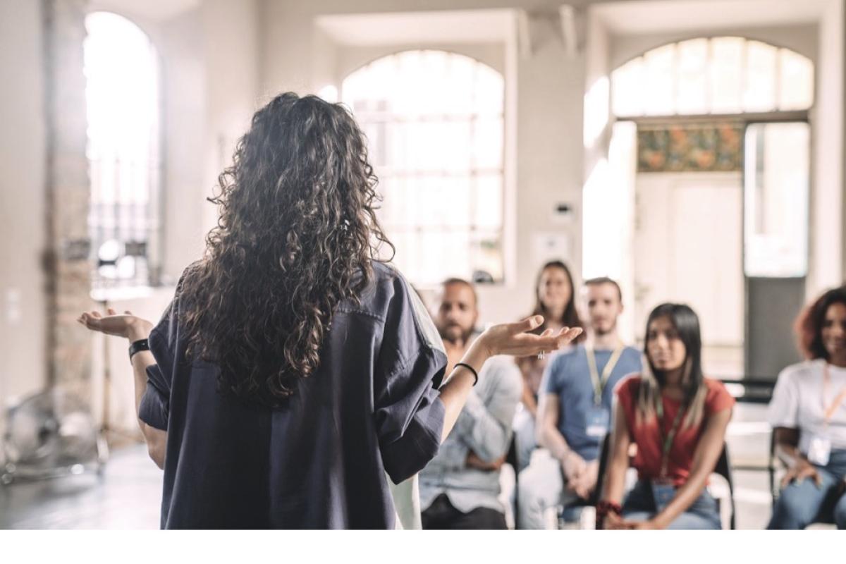 girl speaking in front of group