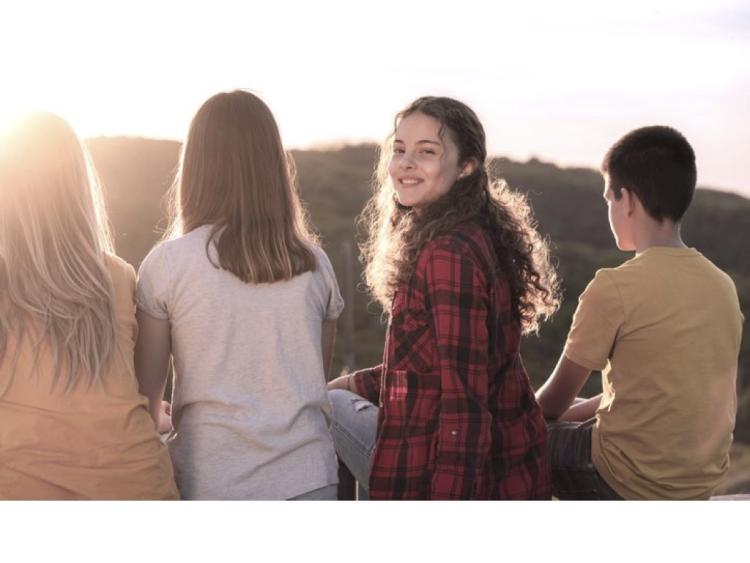 4 kids, one turned around smiling
