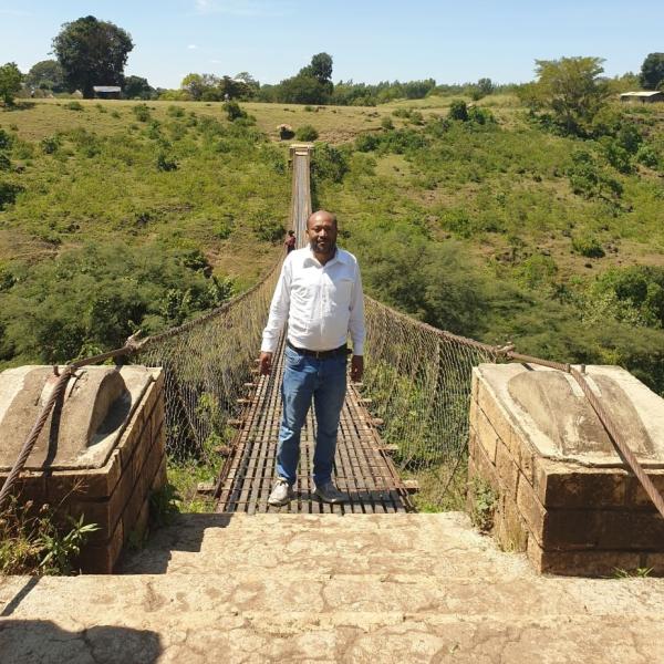 Student standing on a footbridge