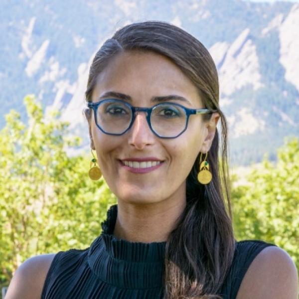 Woman with blue glasses smiles