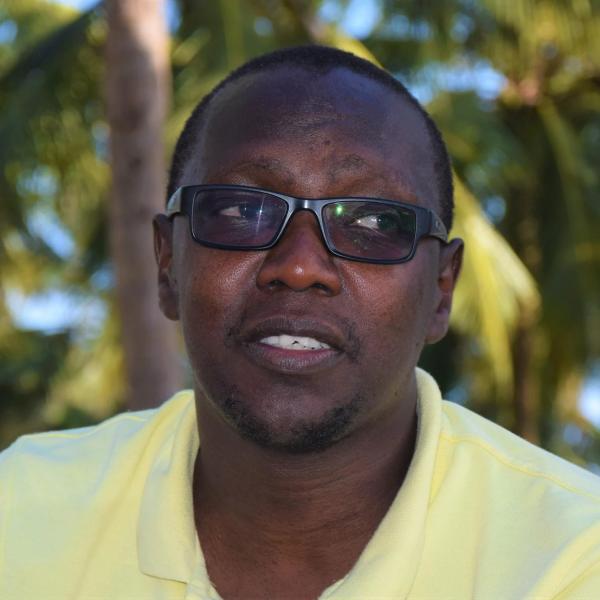 Styvers Kathuni headshot outside yellow shirt