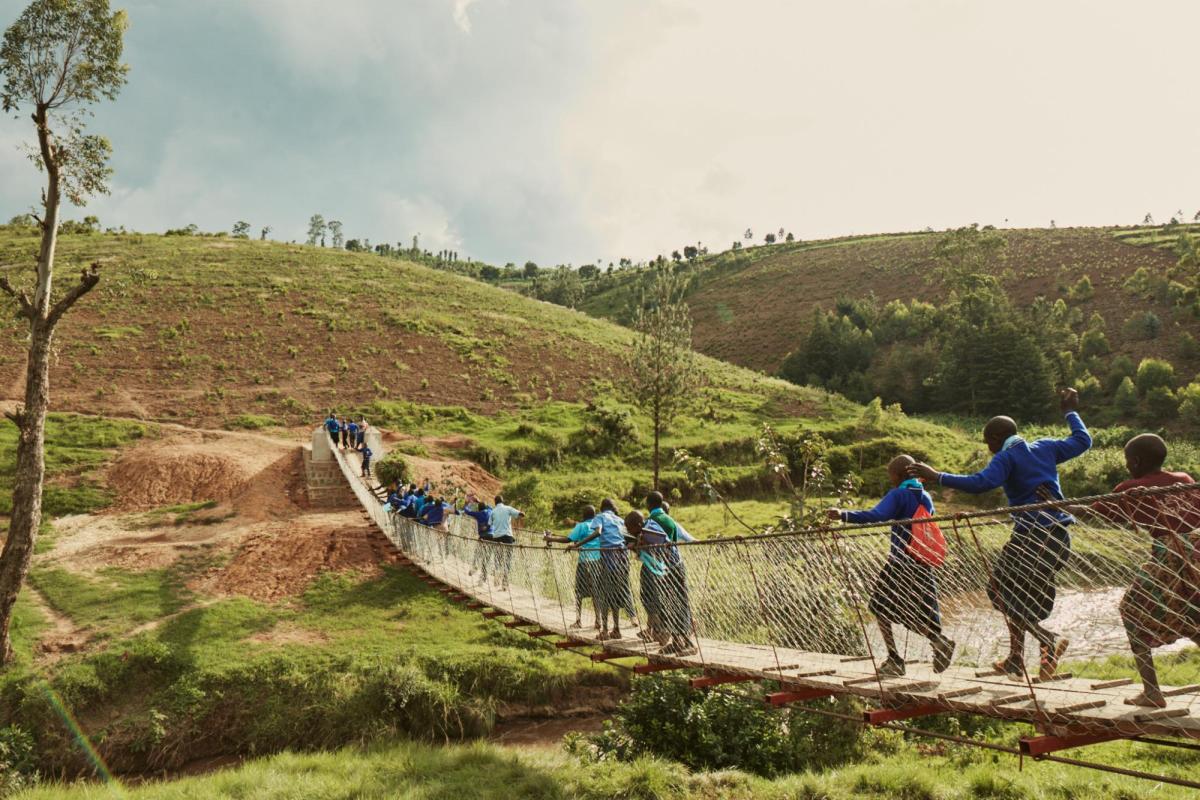 People crossing a rural footbridge