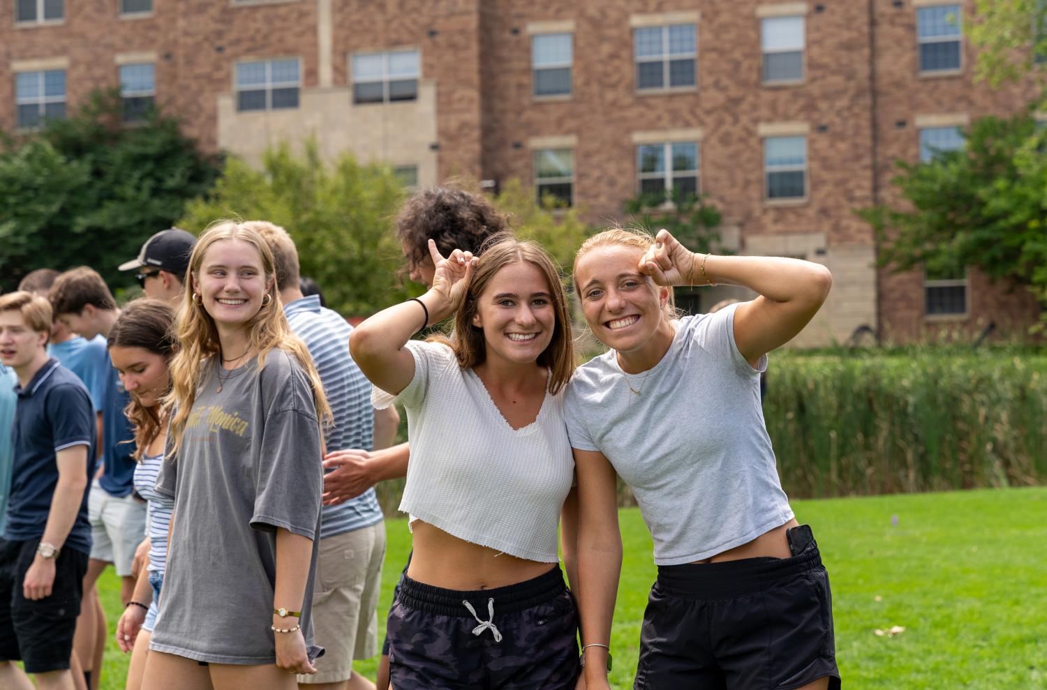 Students making buffalo horns with their pinky fingers
