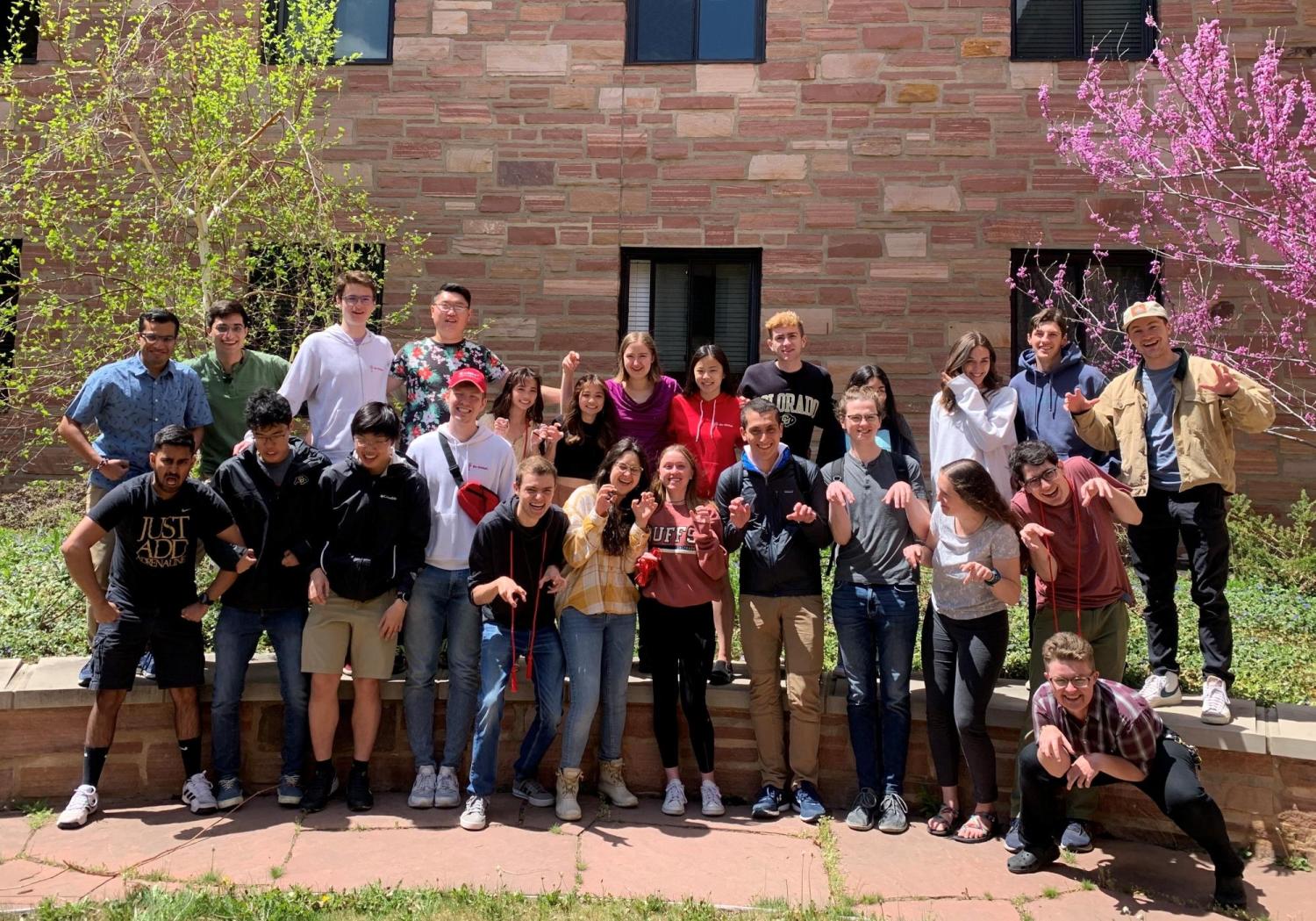 Students acting like they are velociraptors posing for a picture