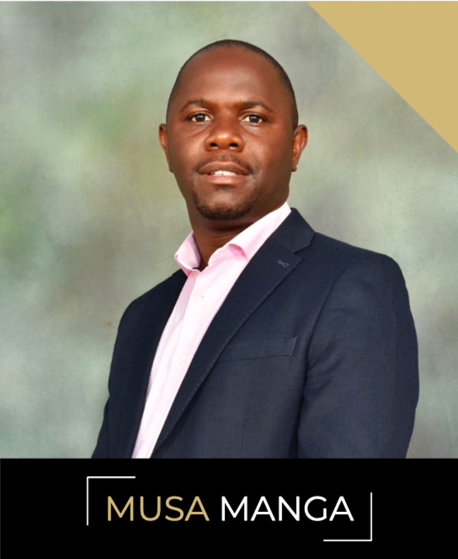 Musa Manga, a man with close-shaven goatee in a black suit jacket and white collared shirt