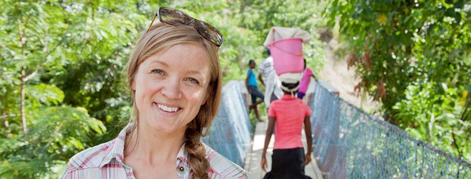 Avery Bang standing on a bridge constructed by Bridges to Prosperity in Haiti