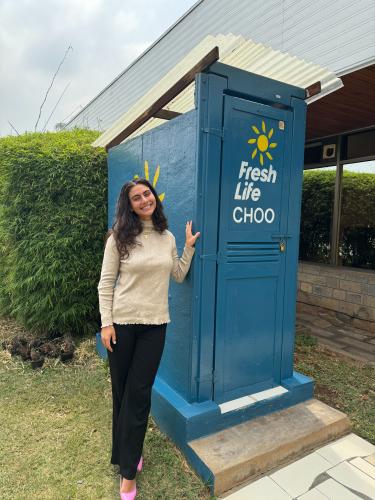 student standing by latrine