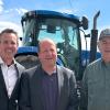 The professor Evan Thomas with the governor and a senator in a field outside