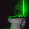 Picture of a toilet with green UV light and spray shooting out