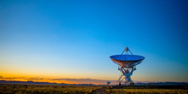 Satellite dish in the desert at dusk