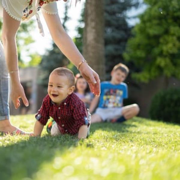 baby crawling through the grass