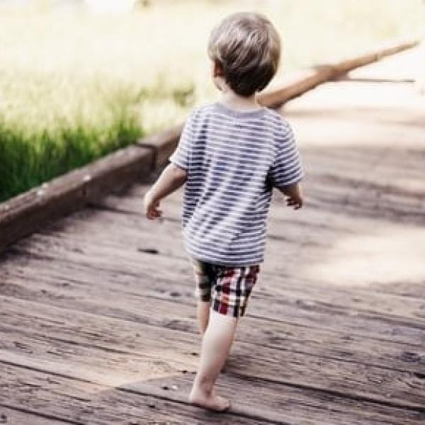 young boy walking away