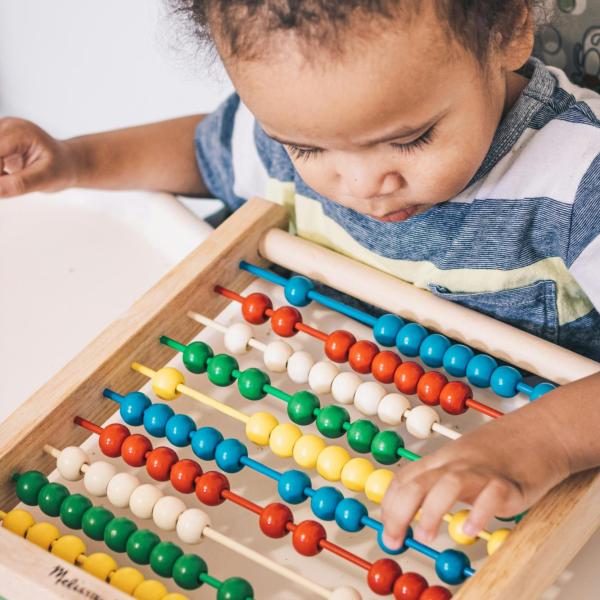 child with abacus toy