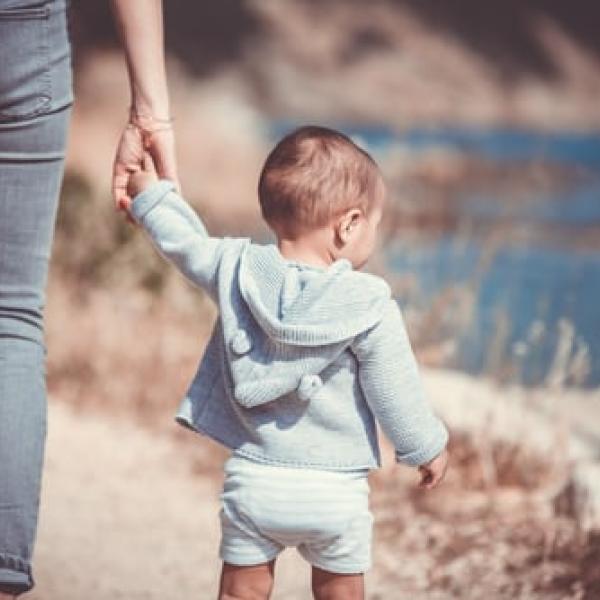 toddler holding hands with parent