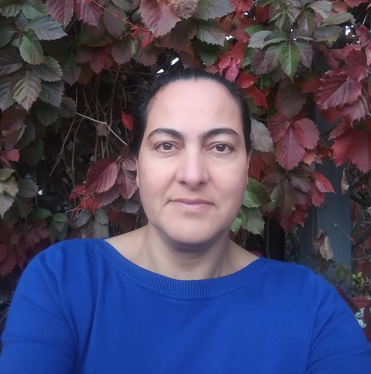 Photo of Veronica, she has dark hair and is wearing a blue shirt
