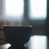 A steaming mug sits on a table 